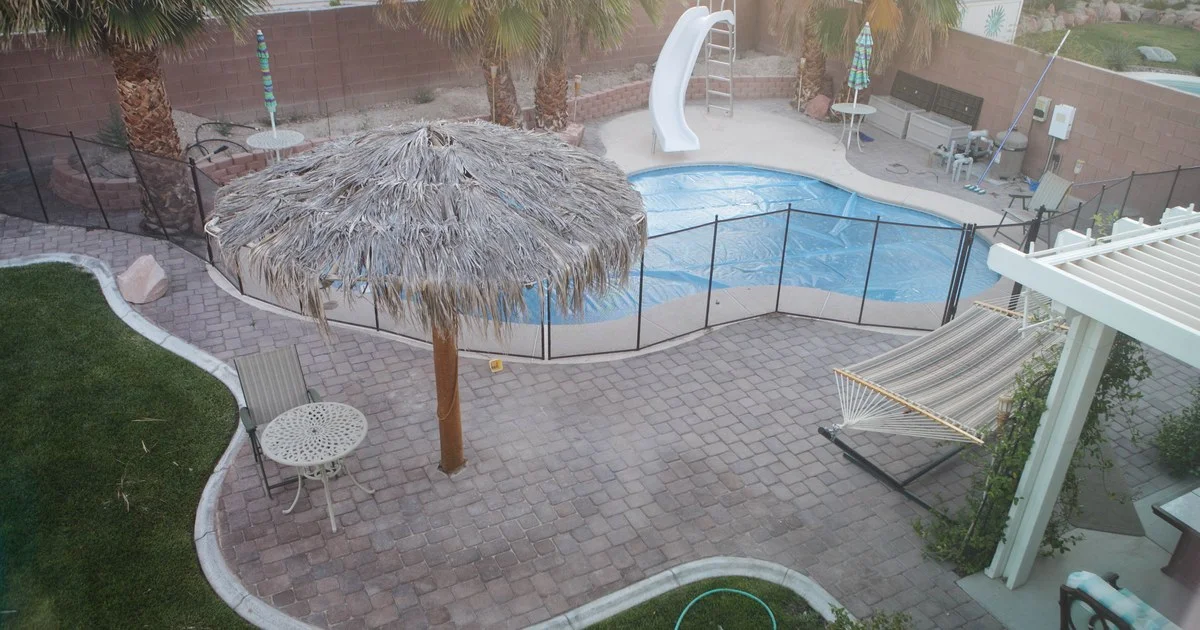 Modern backyard swimming pool and composite deck at dusk, illustrating 2026 pool installation costs