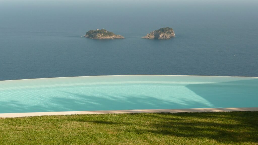 A luxury infinity-edge swimming pool overlooking the sea, illustrating the custom design possibilities at a higher pool budget
