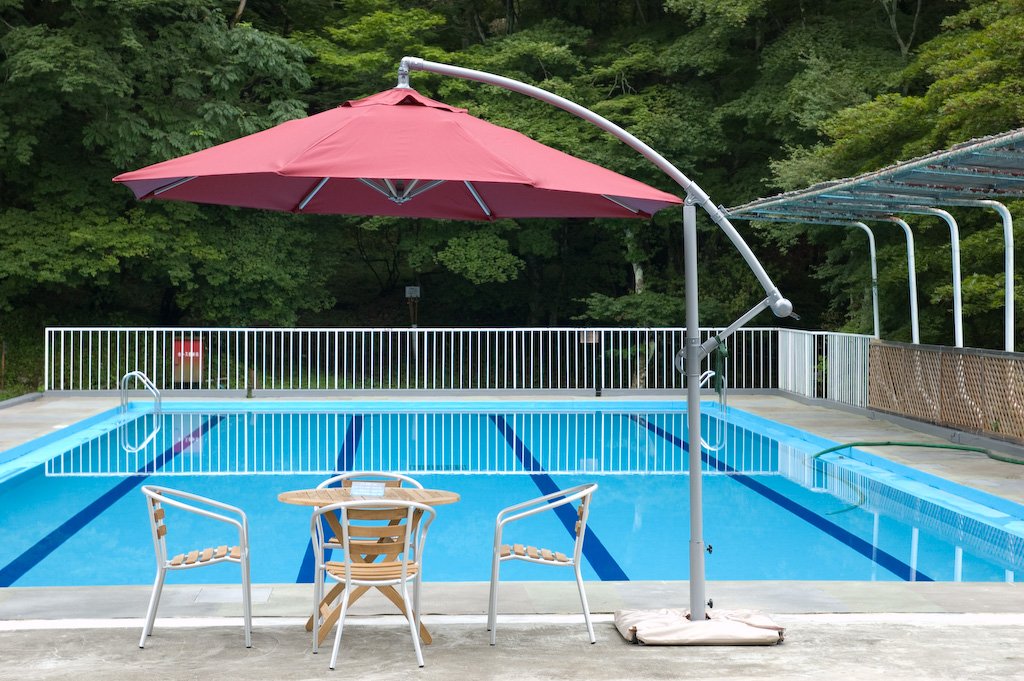 An empty outdoor swimming pool with poolside seating, the kind of project homeowners finance with a HELOC, cash-out refinance, or personal loan