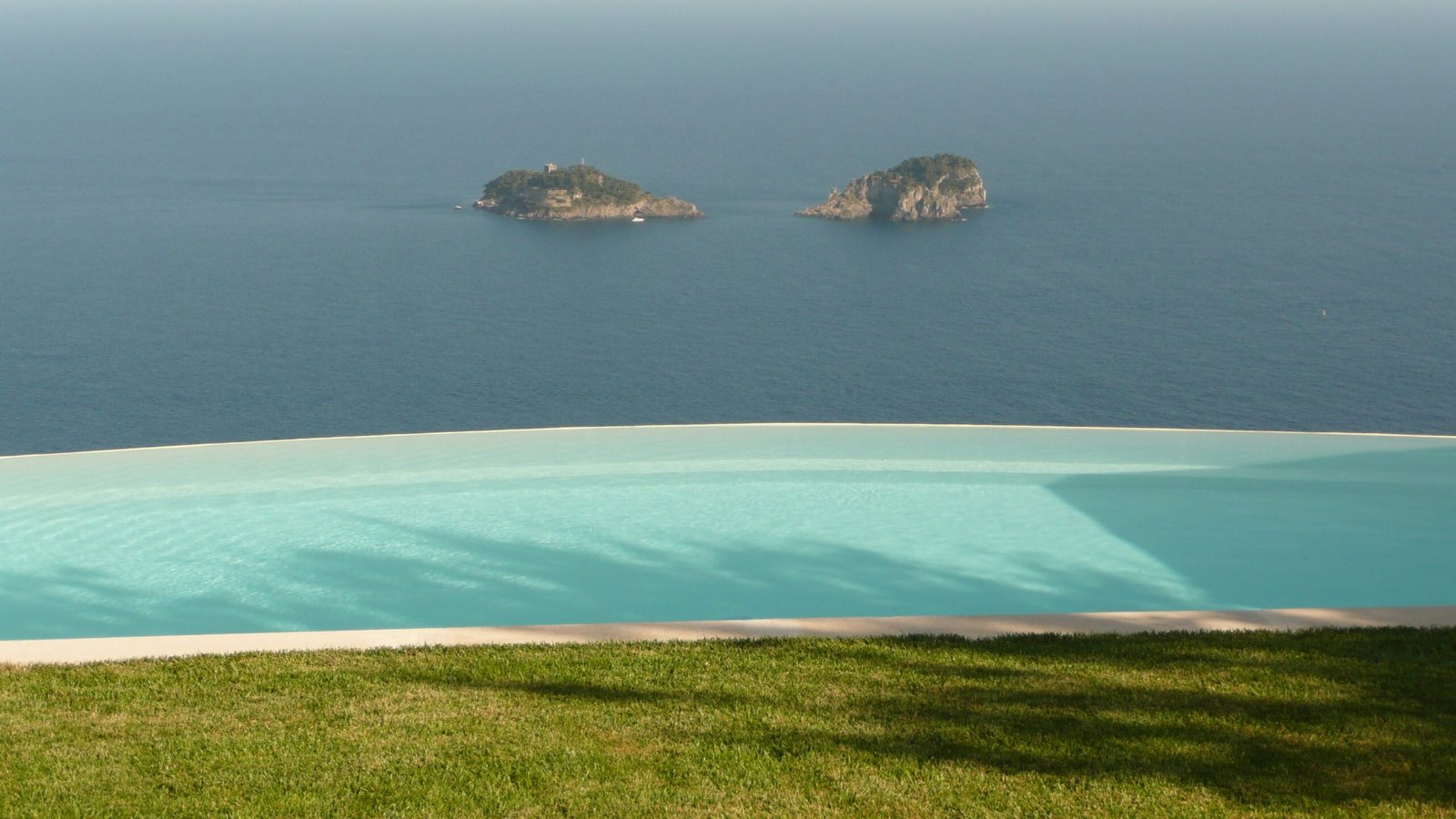 A luxury infinity-edge swimming pool overlooking the sea, illustrating the custom design possibilities at a higher pool budget